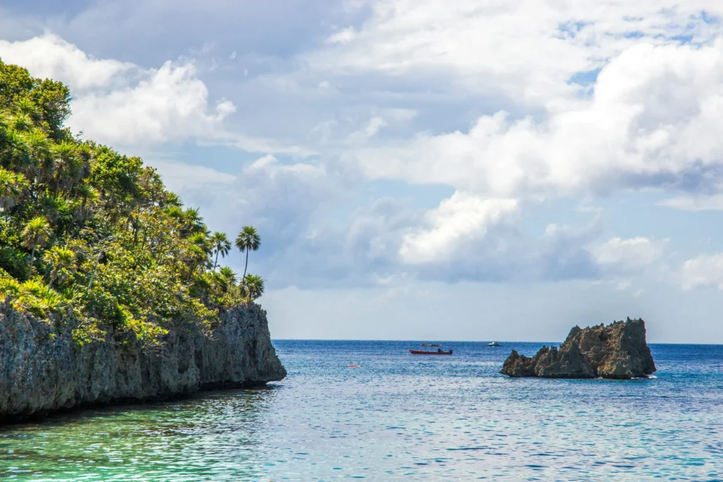 A calm bay with small islands and rock formations.