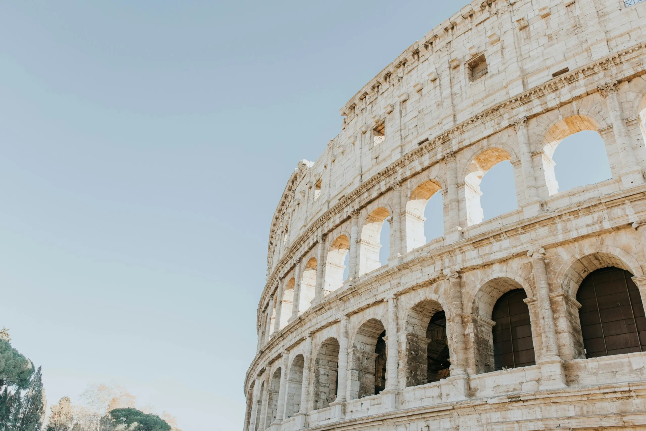 The ancient Roman Colosseum under a bright sky.