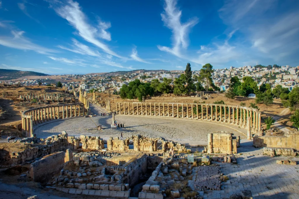 The ancient Roman ruins of Jerash, featuring an oval forum and columns.