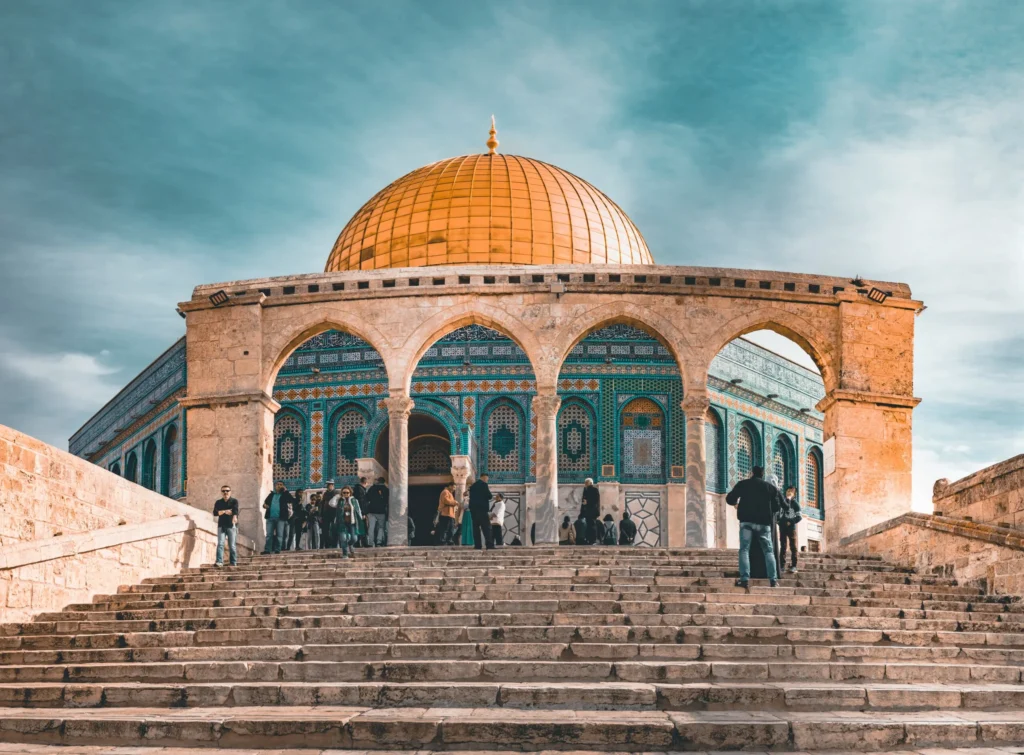 The Dome of the Rock in Jerusalem, with its iconic golden dome and ornate facade.