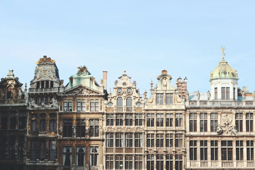 A row of ornate, classical buildings with intricate facades and domes.