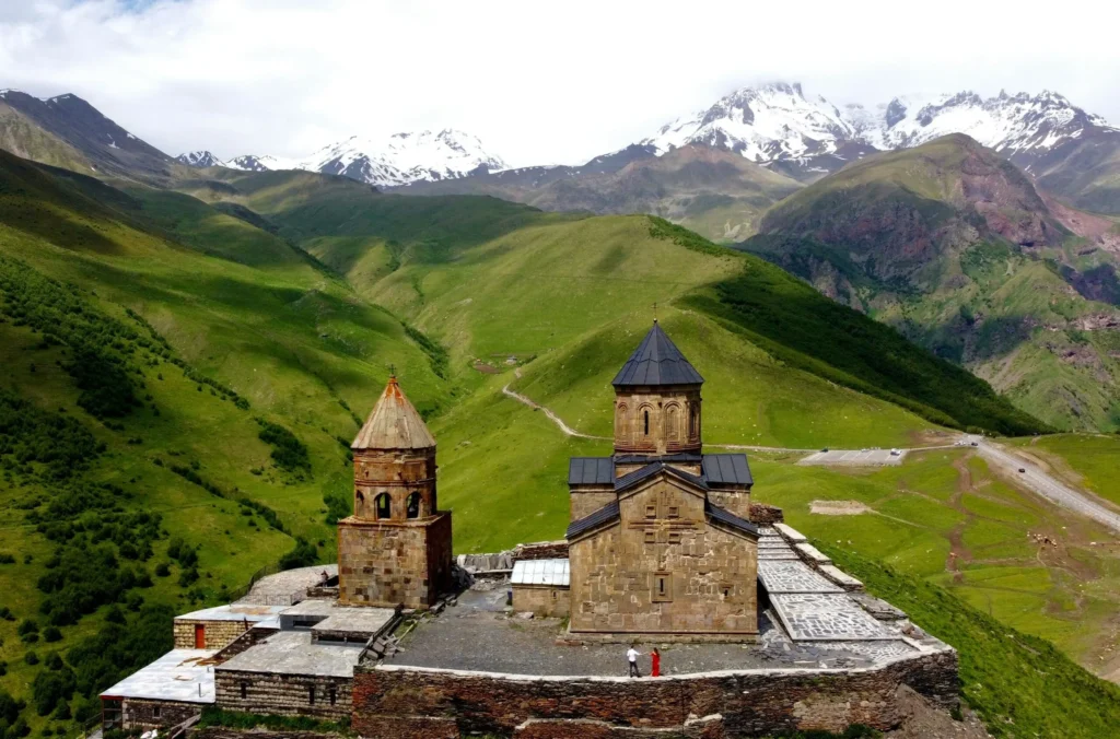 Gergeti Trinity Church in a green mountain valley