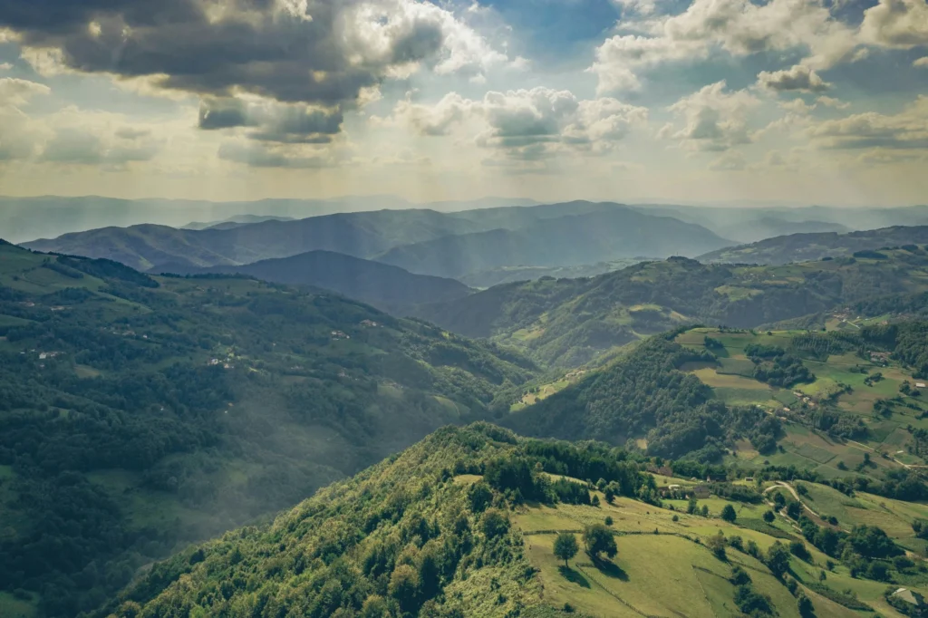 Green hills and valleys under a cloudy sky