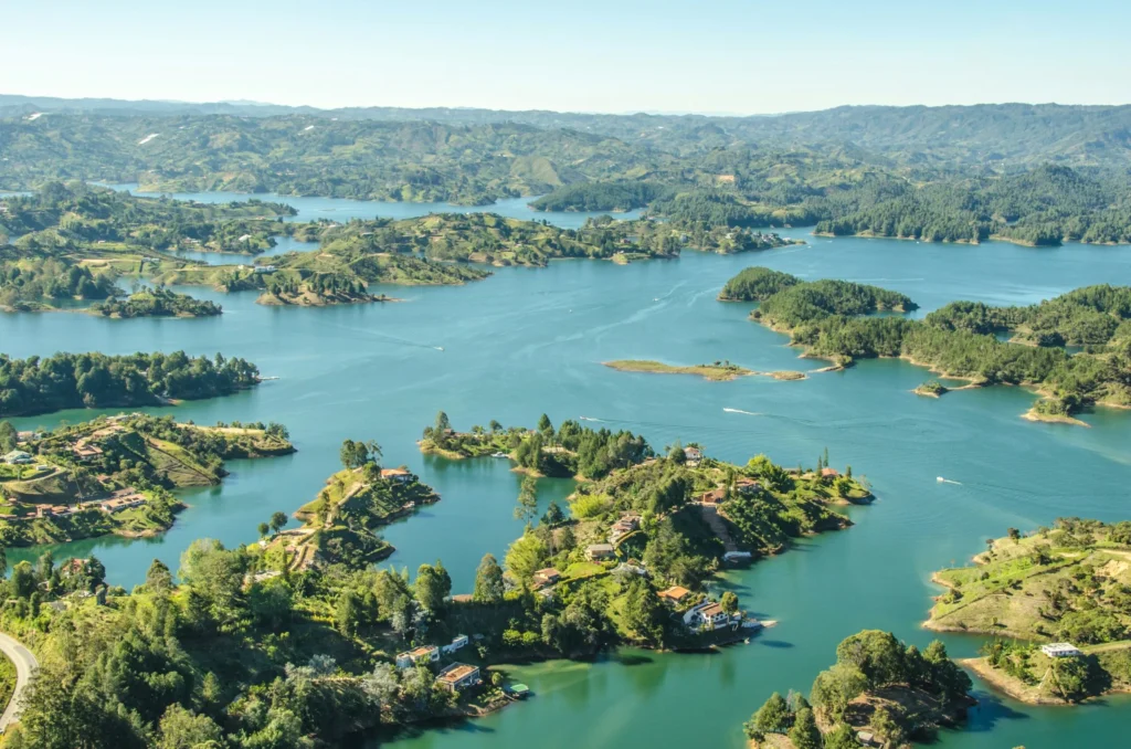 An aerial view of a large lake with numerous small, green islands.