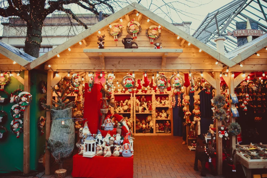 A decorated wooden stall at a Christmas market, filled with various festive goods and decorations.