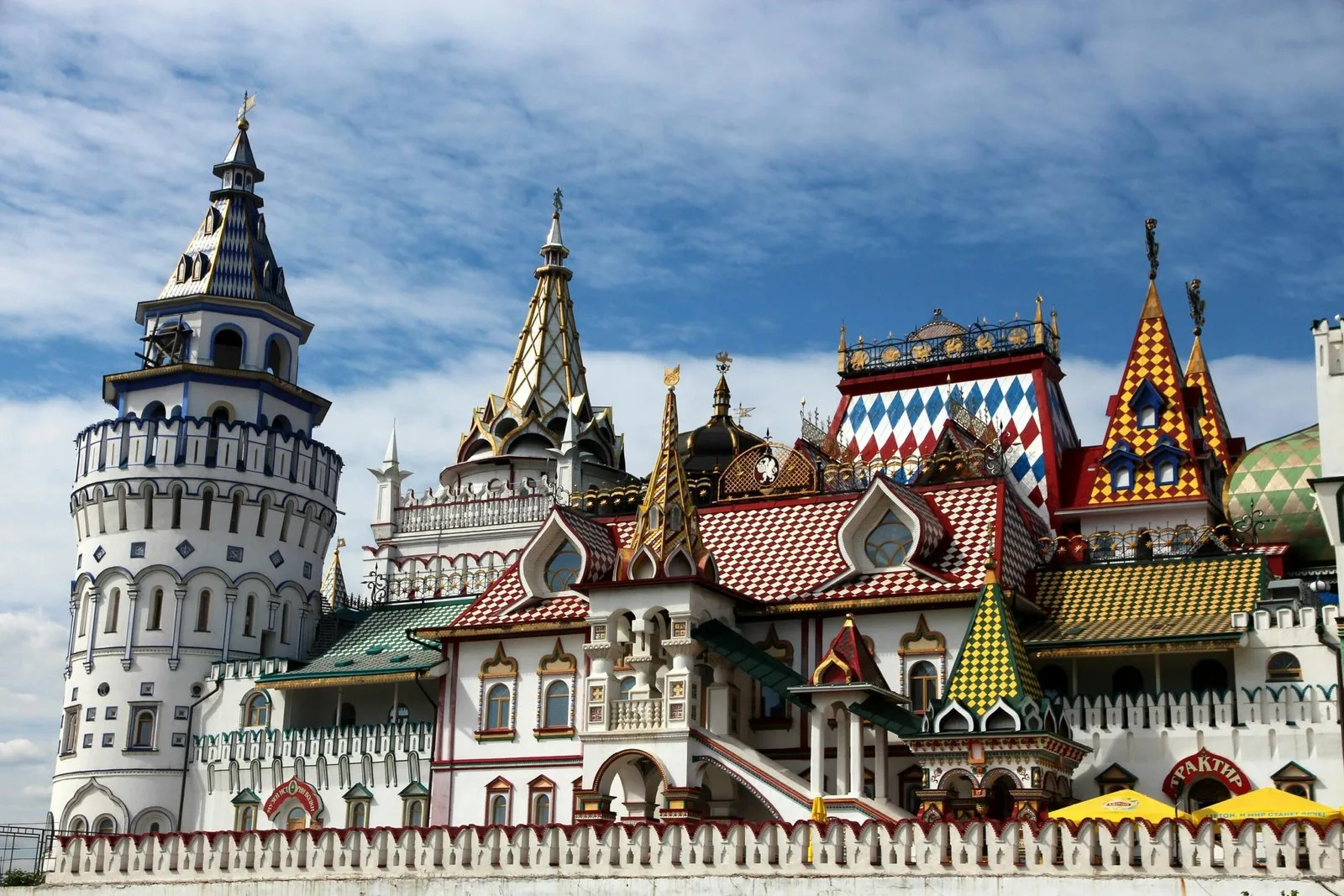 A colorful and ornate fairytale-like building complex with multiple towers and intricate details.