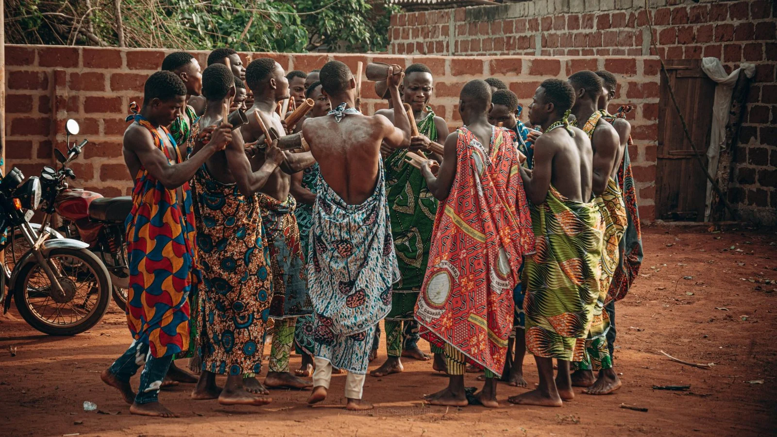 A group of women in colorful traditional clothing dancing in a circle.