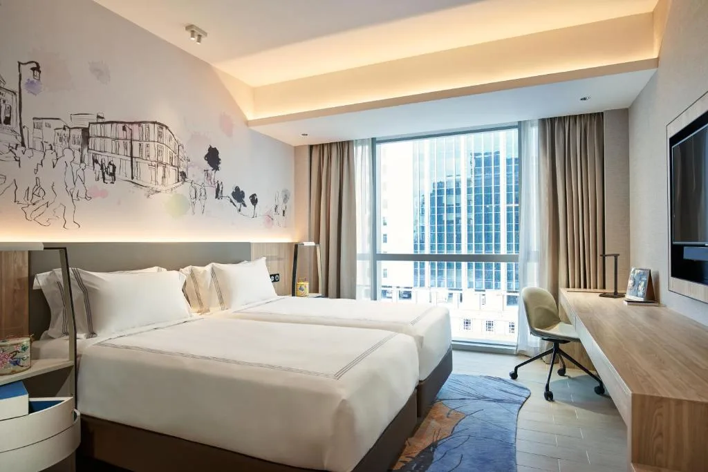 Bright modern hotel room with twin beds and city skyline view, ideal off-season stay for tranquil urban travel.
