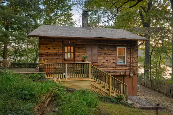 Quiet off-season lakeside cabin rental nestled in empty woods, a serene nature getaway for peaceful travel escape.