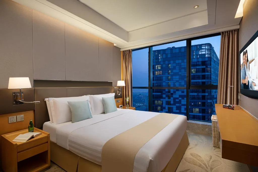 Quiet modern hotel room at dusk with city skyline view, empty off-season retreat ideal for peaceful urban stay.