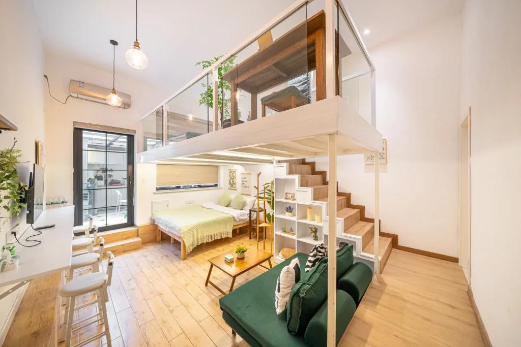 Bright, quiet loft-style vacation rental interior with mezzanine bed, natural light and minimalist off-season retreat vibe