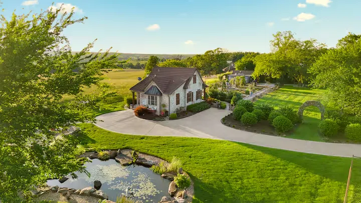 Serene off-season countryside cottage ideal for travel retreats, with manicured gardens, koi pond and rolling fields.