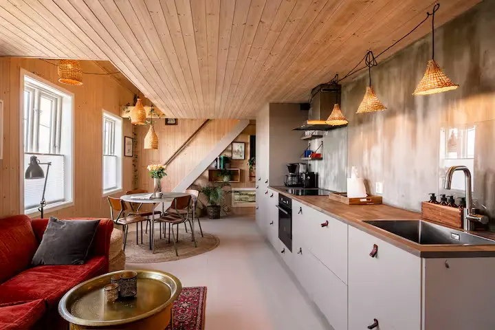 Cozy off-season cabin interior with wood walls, modern kitchen, dining area and lounge for a quiet getaway