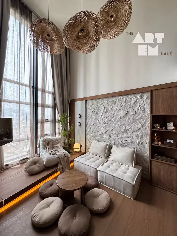 Sunlit boutique hotel lounge in off-season travel, minimalist design, panoramic windows, earthy decor and cozy low seating