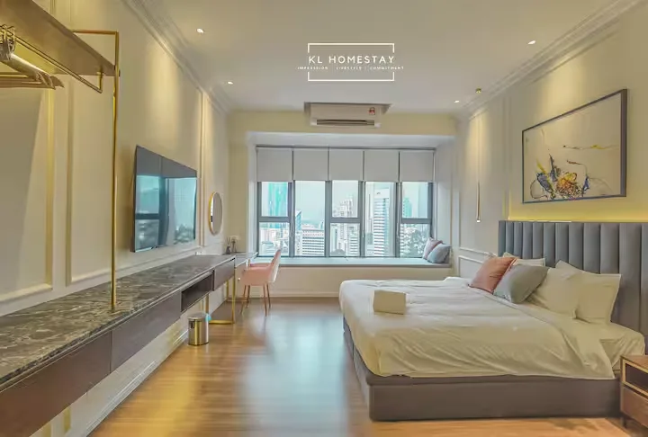 Modern Kuala Lumpur homestay bedroom with city skyline view, serene off-season ambiance and unoccupied travel retreat.
