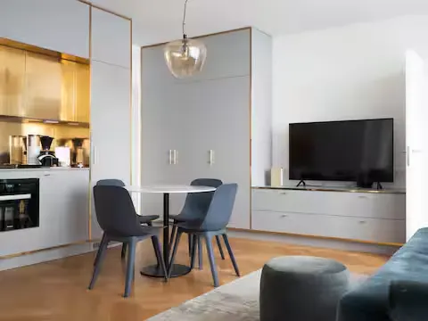 Modern studio vacation rental with kitchenette and dining area, bathed in soft natural light for a quiet off-season getaway