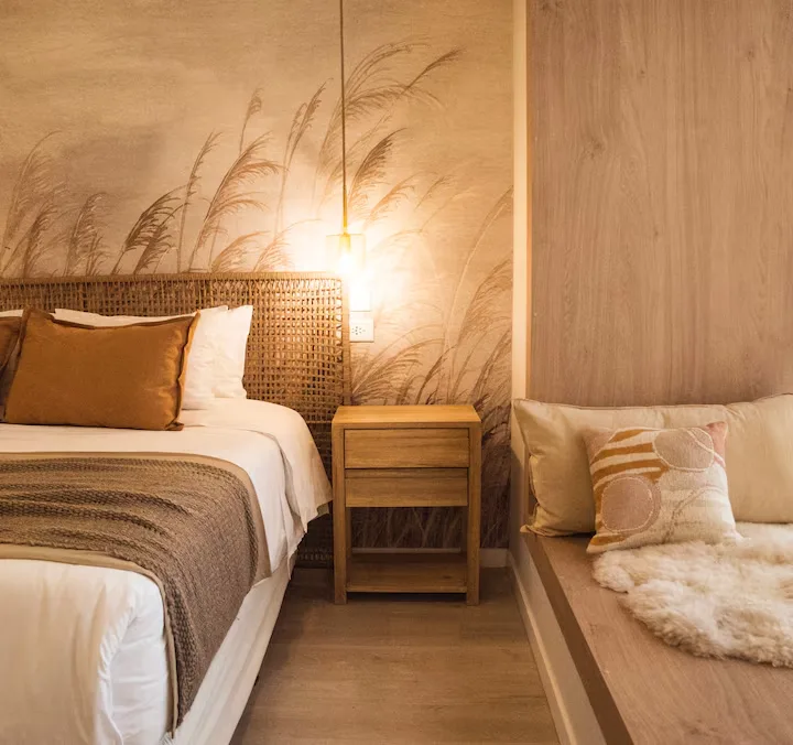 Cozy boutique hotel room with warm wood accents and soft lighting, perfect off-season travel retreat